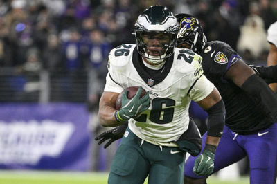 Dec 1, 2024; Baltimore, Maryland, USA; Philadelphia Eagles running back Saquon Barkley (26) rushes past Baltimore Ravens linebacker Roquan Smith (0) during the second  half  at M&T Bank Stadium. Mandatory Credit: Tommy Gilligan-Imagn Images