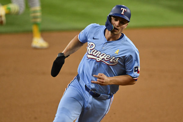 Sep 1, 2024; Arlington, Texas, USA; Texas Rangers shortstop Corey Seager (5) scores from second base on a double hit by right fielder Adolis Garcia (not pictured) during the first inning at Globe Life Field. Mandatory Credit: Jerome Miron-USA TODAY Sports