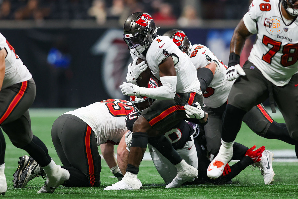 Oct 3, 2024; Atlanta, Georgia, USA; Tampa Bay Buccaneers running back Rachaad White (1) runs the ball against the Atlanta Falcons in the first quarter at Mercedes-Benz Stadium. Credit: Brett Davis-Imagn Images