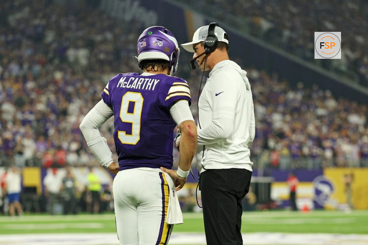 Sep 14, 2025; Minneapolis, Minnesota, USA; Minnesota Vikings quarterback J.J. McCarthy (9) speaks with Minnesota Vikings head coach Kevin O'Connell during the first half against the Atlanta Falcons at U.S. Bank Stadium. Credit: Matt Krohn-Imagn Images