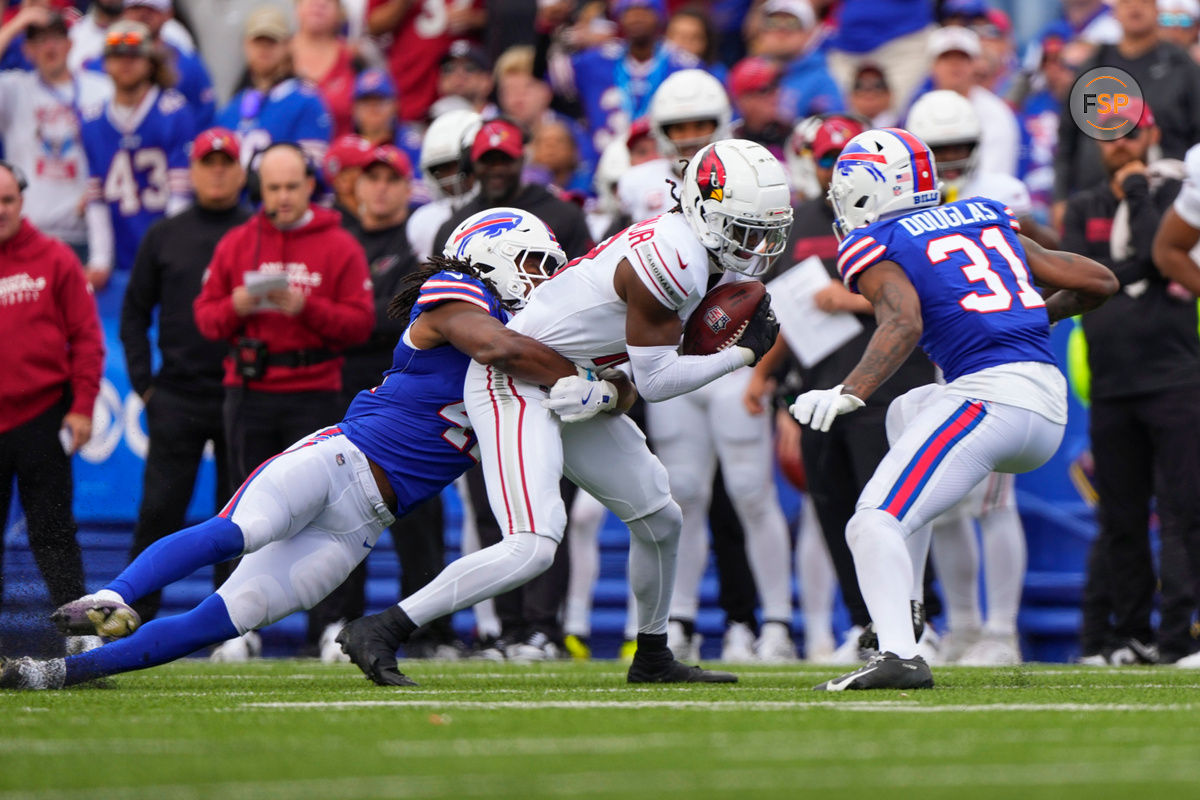 Sep 8, 2024; Orchard Park, New York, USA; Buffalo Bills linebacker Dorian Williams (42) and Buffalo Bills cornerback Rasul Douglas (31) tackle Arizona Cardinals wide receiver Marvin Harrison Jr. (18) during the first half at Highmark Stadium. Credit: Gregory Fisher-Imagn Images