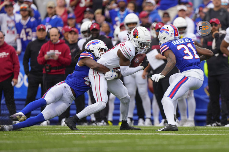 Sep 8, 2024; Orchard Park, New York, USA; Buffalo Bills linebacker Dorian Williams (42) and Buffalo Bills cornerback Rasul Douglas (31) tackle Arizona Cardinals wide receiver Marvin Harrison Jr. (18) during the first half at Highmark Stadium. Credit: Gregory Fisher-Imagn Images