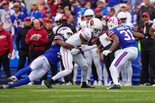 Sep 8, 2024; Orchard Park, New York, USA; Buffalo Bills linebacker Dorian Williams (42) and Buffalo Bills cornerback Rasul Douglas (31) tackle Arizona Cardinals wide receiver Marvin Harrison Jr. (18) during the first half at Highmark Stadium. Mandatory Credit: Gregory Fisher-Imagn Images