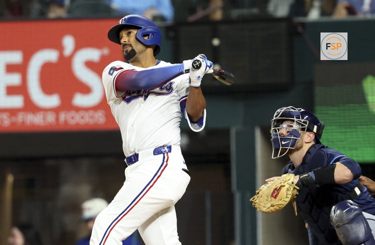 Apr 5, 2025; Arlington, Texas, USA; Texas Rangers second baseman Marcus Semien (2) hits a home run during the first inning against the Tampa Bay Rays at Globe Life Field. Credit: Kevin Jairaj-Imagn Images