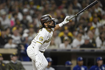 Oct 9, 2024; San Diego, California, USA; San Diego Padres outfielder Fernando Tatis Jr. (23) doubles in the third inning against the Los Angeles Dodgers during game four of the NLDS for the 2024 MLB Playoffs at Petco Park.  Mandatory Credit: Denis Poroy-Imagn Images