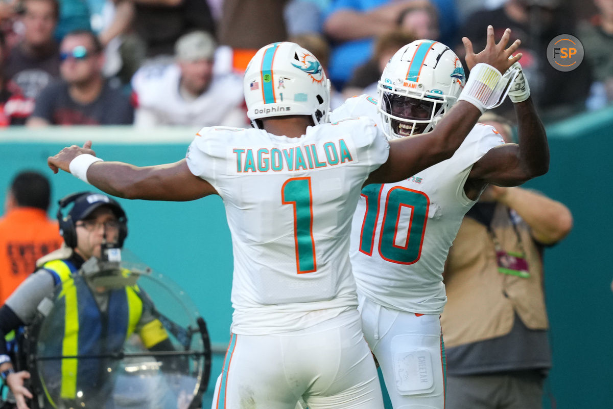 Nov 13, 2022; Miami Gardens, Florida, USA; Miami Dolphins wide receiver Tyreek Hill (10) celebrates the touchdown of running back quarterback Tua Tagovailoa (1)  during the second half at Hard Rock Stadium. Credit: Jasen Vinlove-USA TODAY Sports