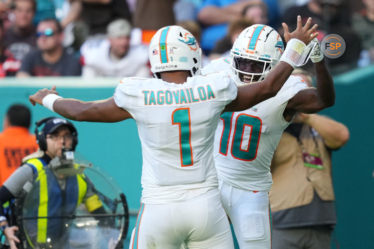 Nov 13, 2022; Miami Gardens, Florida, USA; Miami Dolphins wide receiver Tyreek Hill (10) celebrates the touchdown of running back quarterback Tua Tagovailoa (1)  during the second half at Hard Rock Stadium. Credit: Jasen Vinlove-USA TODAY Sports