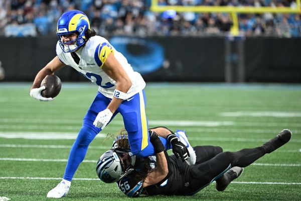 Jan 10, 2026; Charlotte, NC, USA; Los Angeles Rams wide receiver Puka Nacua (12) with the ball as Carolina Panthers linebacker Christian Rozeboom (56) defends in the first quarter in an NFC Wild Card Round game at Bank of America Stadium. Mandatory Credit: Bob Donnan-Imagn Images