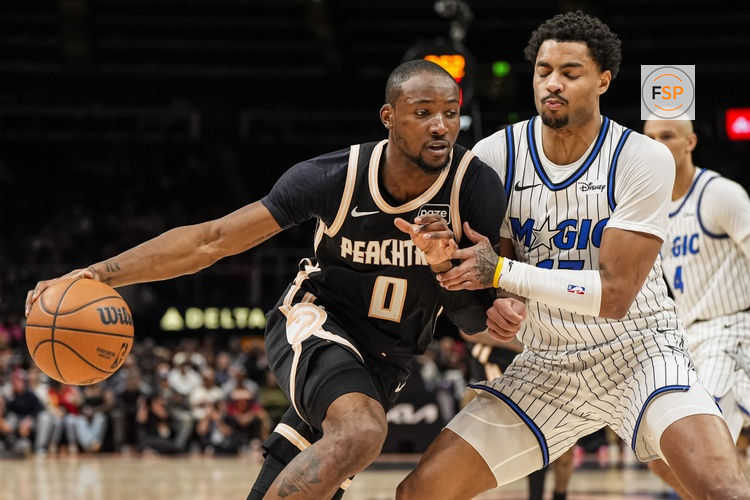 Mar 16, 2026; Atlanta, Georgia, USA; Atlanta Hawks forward Jonathan Kuminga (0) dribbles against Orlando Magic guard Jett Howard (13) during the second half at State Farm Arena. Credit: Dale Zanine-Imagn Images