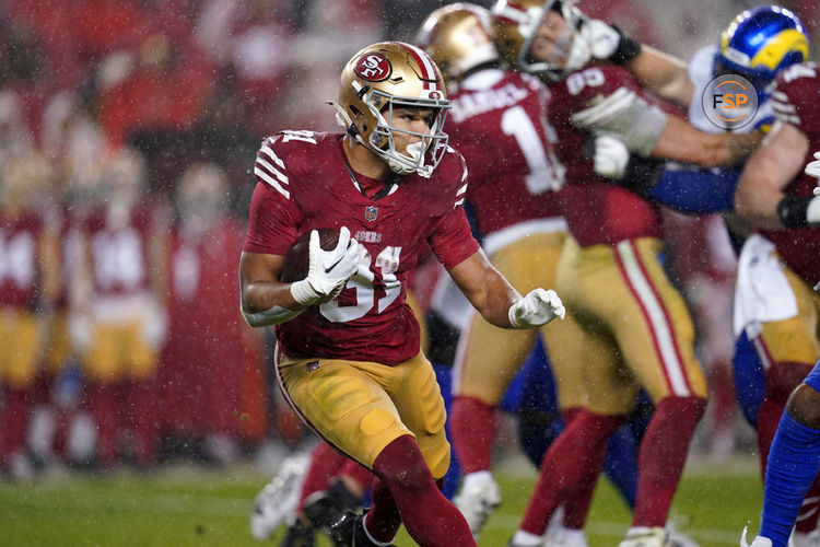 Dec 12, 2024; Santa Clara, California, USA; San Francisco 49ers running back Isaac Guerendo (31) runs the ball against the Los Angeles Rams in the second quarter at Levi's Stadium. Credit: Cary Edmondson-Imagn Images