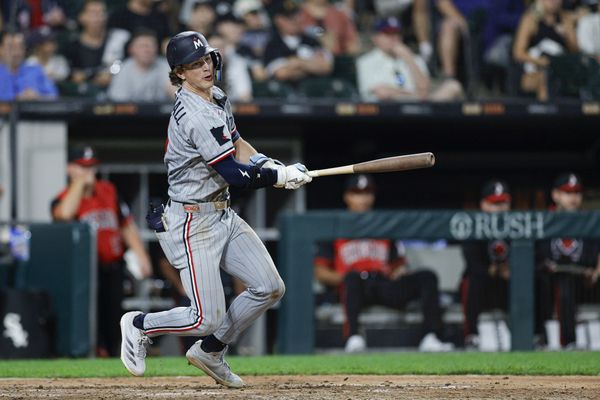 Aug 22, 2025; Chicago, Illinois, USA; Minnesota Twins second baseman Luke Keaschall (15) hits an RBI-single against the Chicago White Sox during the sixth inning at Rate Field. Mandatory Credit: Kamil Krzaczynski-Imagn Images
