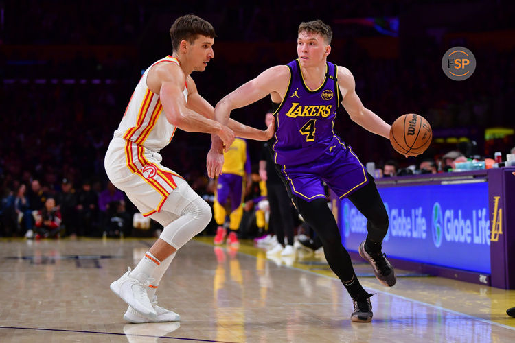 Jan 3, 2025; Los Angeles, California, USA; Los Angeles Lakers guard Dalton Knecht (4) moves the ball against Atlanta Hawks guard Bogdan Bogdanovic (13) during the second half at Crypto.com Arena. Credit: Gary A. Vasquez-Imagn Images