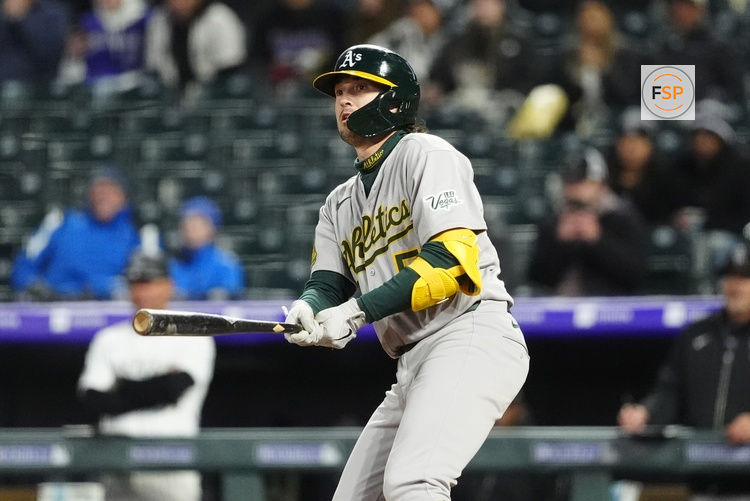 Apr 5, 2025; Denver, Colorado, USA; Athletics shortstop Jacob Wilson (5) RBI doubles in the sixth inning against the Colorado Rockies at Coors Field. Credit: Ron Chenoy-Imagn Images
