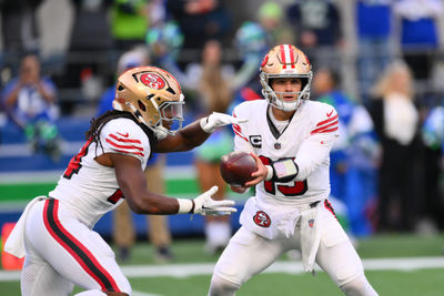 Oct 10, 2024; Seattle, Washington, USA; San Francisco 49ers quarterback Brock Purdy (13) hands the ball off to running back Jordan Mason (24) during the first half against the Seattle Seahawks at Lumen Field. Mandatory Credit: Steven Bisig-Imagn Images