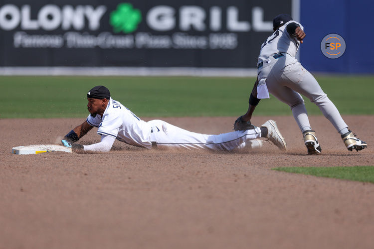 Apr 20, 2025; Tampa, Florida, USA; Tampa Bay Rays center fielder Chandler Simpson (14) steals second base against the New York Yankees in the eighth inning at George M. Steinbrenner Field. Credit: Nathan Ray Seebeck-Imagn Images