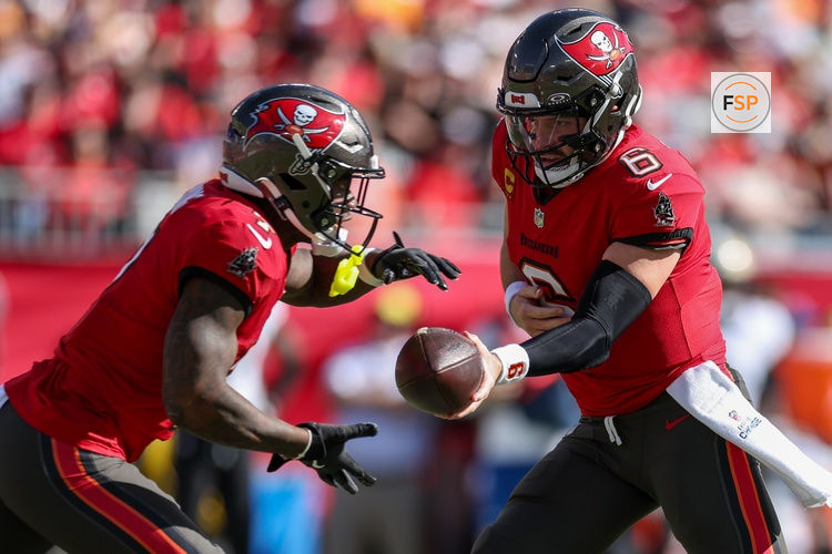 Jan 5, 2025; Tampa, Florida, USA; Tampa Bay Buccaneers quarterback Baker Mayfield (6) hands off to running back Bucky Irving (7) against the New Orleans Saints in the second quarter  at Raymond James Stadium. Credit: Nathan Ray Seebeck-Imagn Images