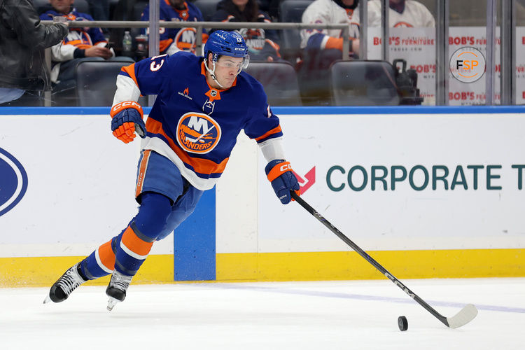 Jan 25, 2025; Elmont, New York, USA; New York Islanders center Mathew Barzal (13) plays the puck against the Carolina Hurricanes during the third period at UBS Arena. Credit: Brad Penner-Imagn Images