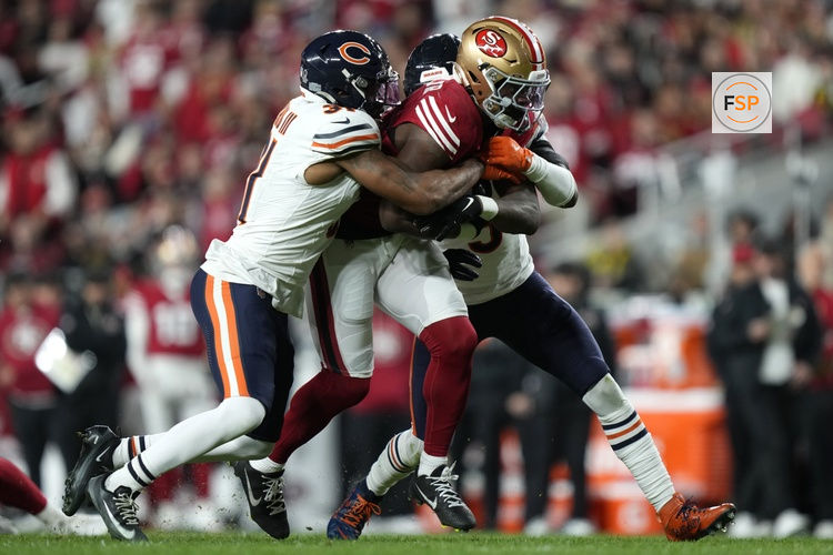 Dec 28, 2025; Santa Clara, California, USA;  Chicago Bears safety Kevin Byard III (31) and safety Jaquan Brisker (9) tackle San Francisco 49ers running back Brian Robinson Jr. (3) in the first half at Levi's Stadium. Credit: Kyle Terada-Imagn Images