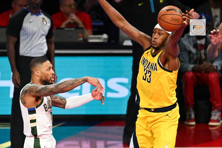 Dec 7, 2023; Las Vegas, Nevada, USA; Indiana Pacers center Myles Turner (33) gets a hand on a pass by Milwaukee Bucks guard Damian Lillard (0) during the first quarter at T-Mobile Arena. Credit: Candice Ward-USA TODAY Sports