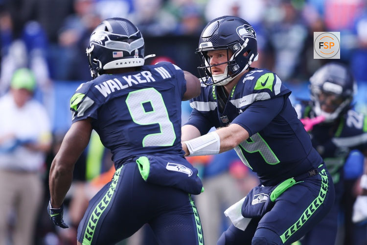 Nov 9, 2025; Seattle, Washington, USA; Seattle Seahawks quarterback Sam Darnold (14) hands the ball off to Seattle Seahawks running back Kenneth Walker III (9) during the first quarter at Lumen Field. Credit: Kevin Ng-Imagn Images