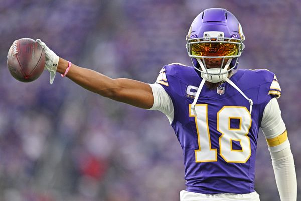 Sep 14, 2025; Minneapolis, Minnesota, USA; Minnesota Vikings wide receiver Justin Jefferson (18) holds out the ball before the game against the Atlanta Falcons at U.S. Bank Stadium. Mandatory Credit: Jeffrey Becker-Imagn Images