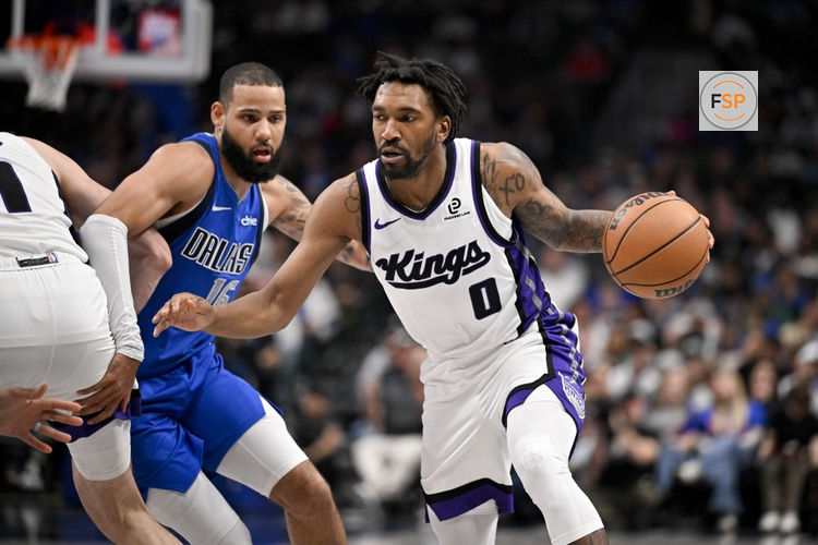 Feb 26, 2026; Dallas, Texas, USA; Sacramento Kings guard Malik Monk (0) moves the past Dallas Mavericks forward Caleb Martin (16) during the second half at the American Airlines Center. Credit: Jerome Miron-Imagn Images