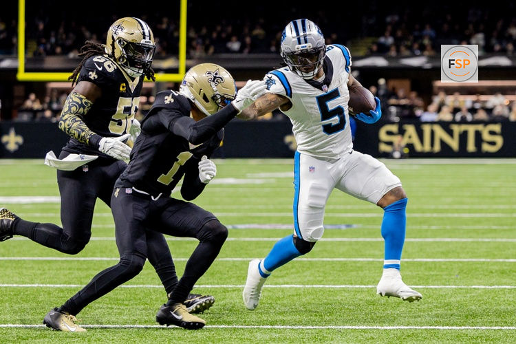 Dec 14, 2025; New Orleans, Louisiana, USA; Carolina Panthers running back Rico Dowdle (5) blocks New Orleans Saints cornerback Alontae Taylor (1) during the second quarter at Caesars Superdome. Credit: Stephen Lew-Imagn Images
