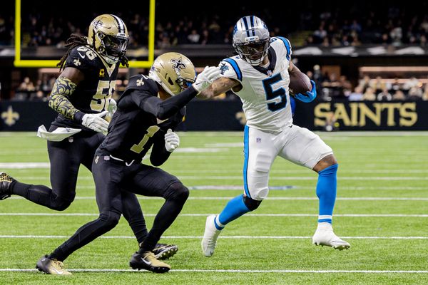 Dec 14, 2025; New Orleans, Louisiana, USA; Carolina Panthers running back Rico Dowdle (5) blocks New Orleans Saints cornerback Alontae Taylor (1) during the second quarter at Caesars Superdome. Mandatory Credit: Stephen Lew-Imagn Images