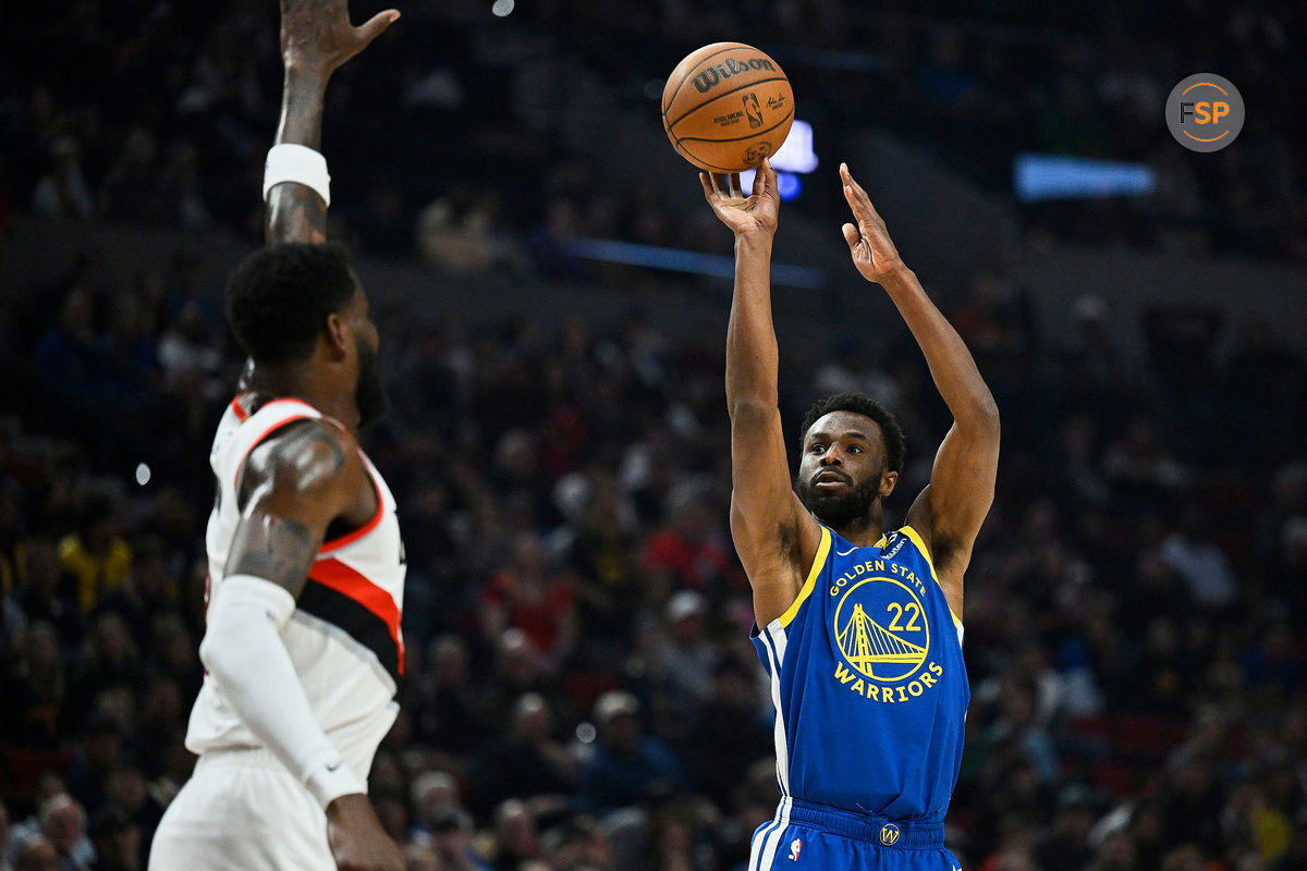 Apr 11, 2024; Portland, Oregon, USA; Golden State Warriors forward Andrew Wiggins (22) shoots a jump shot during the firs half against Portland Trail Blazers center Deandre Ayton (2) at Moda Center. Credit: Troy Wayrynen-USA TODAY Sports