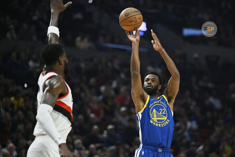 Apr 11, 2024; Portland, Oregon, USA; Golden State Warriors forward Andrew Wiggins (22) shoots a jump shot during the firs half against Portland Trail Blazers center Deandre Ayton (2) at Moda Center. Credit: Troy Wayrynen-USA TODAY Sports