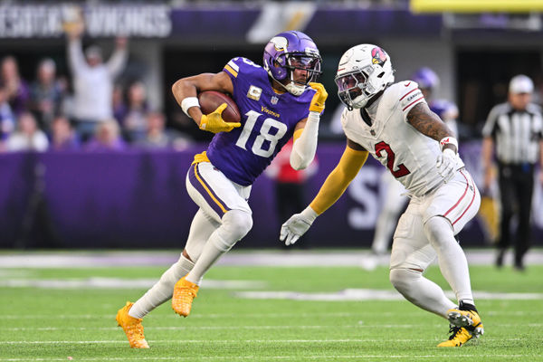 Dec 1, 2024; Minneapolis, Minnesota, USA; Minnesota Vikings wide receiver Justin Jefferson (18) gets yards after the catch as Arizona Cardinals linebacker Mack Wilson Sr. (2) looks to make the tackle during the fourth quarter at U.S. Bank Stadium. Mandatory Credit: Jeffrey Becker-Imagn Images