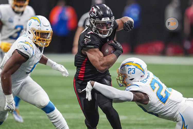 Dec 1, 2024; Atlanta, Georgia, USA; Atlanta Falcons running back Bijan Robinson (7) runs against Los Angeles Chargers safety Tony Jefferson (23) during the second half at Mercedes-Benz Stadium. Credit: Dale Zanine-Imagn Images