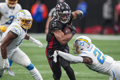 Dec 1, 2024; Atlanta, Georgia, USA; Atlanta Falcons running back Bijan Robinson (7) runs against Los Angeles Chargers safety Tony Jefferson (23) during the second half at Mercedes-Benz Stadium. Mandatory Credit: Dale Zanine-Imagn Images