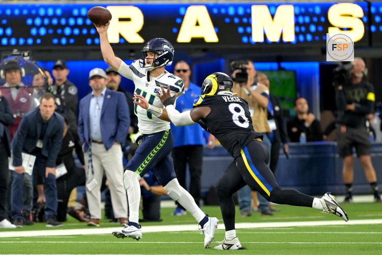 Nov 16, 2025; Inglewood, California, USA;  Seattle Seahawks quarterback Sam Darnold (14) is pressured by Los Angeles Rams linebacker Jared Verse (8) at SoFi Stadium. Credit: Jayne Kamin-Oncea-Imagn Images
