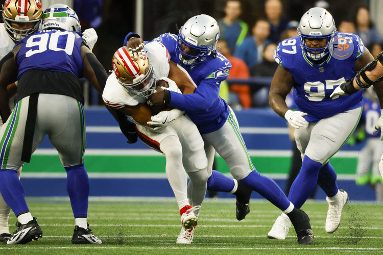 Oct 10, 2024; Seattle, Washington, USA; Seattle Seahawks linebacker Jerome Baker (17) tackles San Francisco 49ers wide receiver Brandon Aiyuk (11) during the second quarter at Lumen Field. Credit: Joe Nicholson-Imagn Images