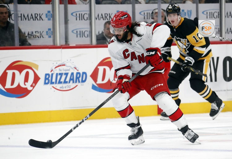 Oct 18, 2024; Pittsburgh, Pennsylvania, USA;  Carolina Hurricanes defenseman Jalen Chatfield (5) handles the puck against the Pittsburgh Penguins during the third period at PPG Paints Arena. Credit: Charles LeClaire-Imagn Images