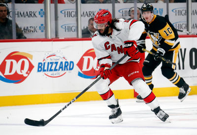 Oct 18, 2024; Pittsburgh, Pennsylvania, USA;  Carolina Hurricanes defenseman Jalen Chatfield (5) handles the puck against the Pittsburgh Penguins during the third period at PPG Paints Arena. Mandatory Credit: Charles LeClaire-Imagn Images