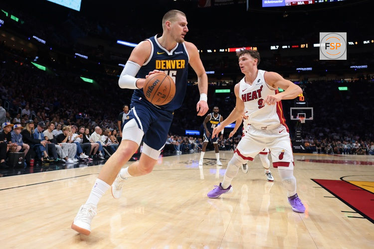 Dec 29, 2025; Miami, Florida, USA; Denver Nuggets center Nikola Jokic (15) drives to the basket against Miami Heat guard Pelle Larsson (9) during the first quarter at Kaseya Center. Credit: Sam Navarro-Imagn Images