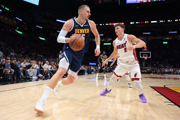 Dec 29, 2025; Miami, Florida, USA; Denver Nuggets center Nikola Jokic (15) drives to the basket against Miami Heat guard Pelle Larsson (9) during the first quarter at Kaseya Center. Mandatory Credit: Sam Navarro-Imagn Images