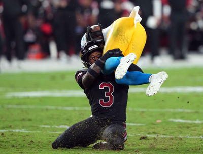 Oct 21, 2024; Glendale, Arizona, USA; Arizona Cardinals safety Budda Baker (3) tackles Los Angeles Chargers wide receiver Joshua Palmer (5) during the first half at State Farm Stadium. Mandatory Credit: Joe Camporeale-Imagn Images