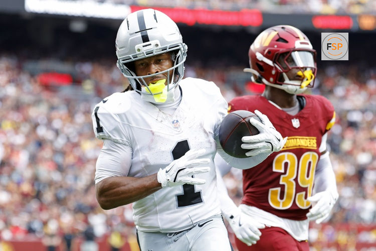 Sep 21, 2025; Landover, Maryland, USA; Las Vegas Raiders wide receiver Tre Tucker (1) celebrates after scoring a touchdown during the second half against the Washington Commanders at Northwest Stadium. Credit: Amber Searls-Imagn Images
