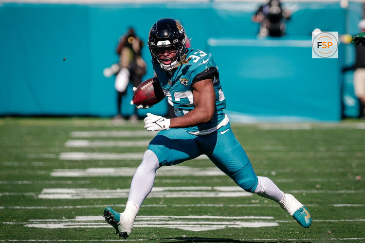 Dec 14, 2025; Jacksonville, Florida, USA;Jacksonville Jaguars running back Bhayshul Tuten (33) runs the ball against the New York Jets at EverBank Stadium. Credit: Travis Register-Imagn Images