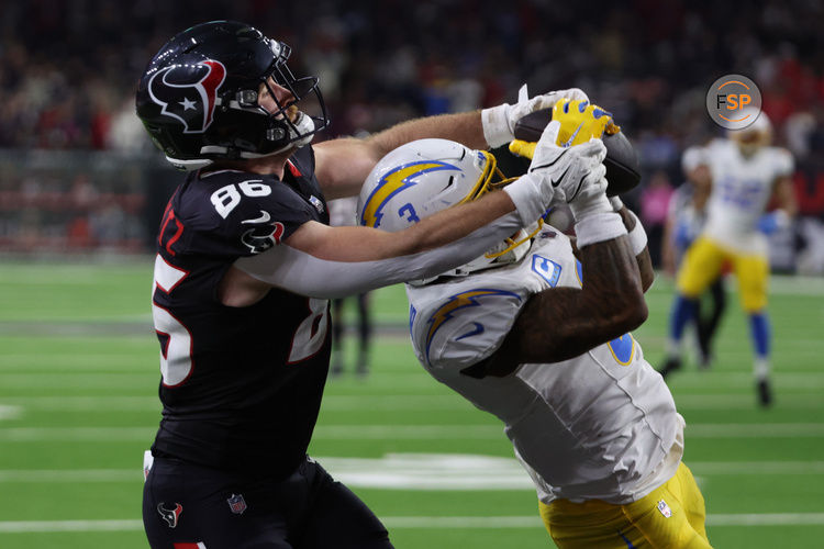 Jan 11, 2025; Houston, Texas, USA;  Los Angeles Chargers safety Derwin Jarnes Jr. (3) intercepts the ball from Houston Texans tight end Dalton Schultz (86) in the third quarter in an AFC wild card game at NRG Stadium. Credit: Thomas Shea-Imagn Images