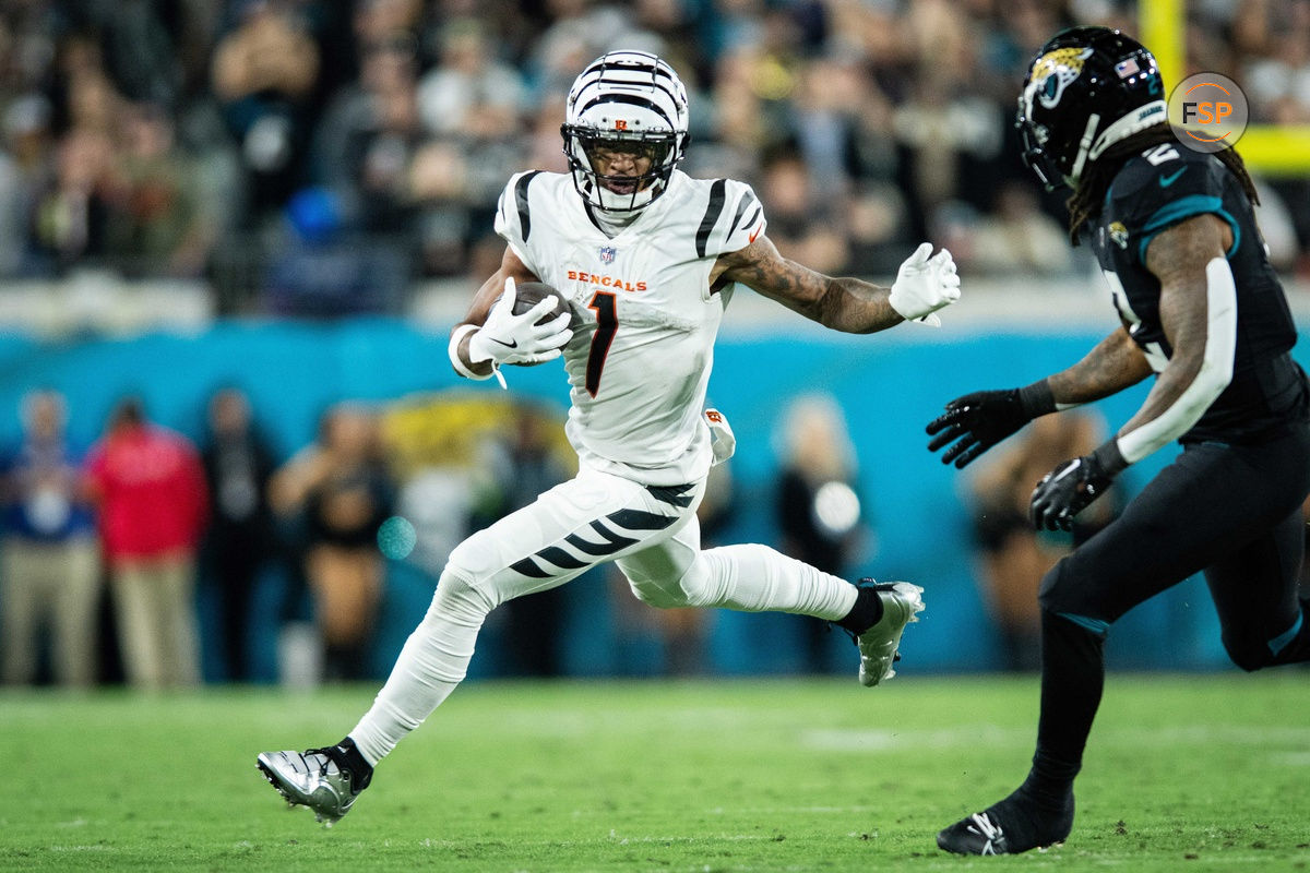 Dec 4, 2023; Jacksonville, Florida, USA; Cincinnati Bengals wide receiver Ja'Marr Chase (1) runs the ball after the catch against Jacksonville Jaguars safety Rayshawn Jenkins (2) in the fourth quarter at EverBank Stadium. Credit: Jeremy Reper-USA TODAY Sports