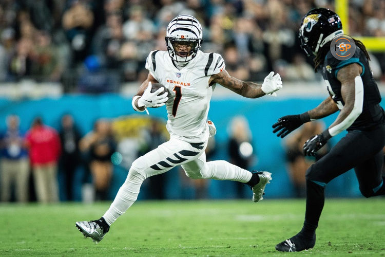 Dec 4, 2023; Jacksonville, Florida, USA; Cincinnati Bengals wide receiver Ja'Marr Chase (1) runs the ball after the catch against Jacksonville Jaguars safety Rayshawn Jenkins (2) in the fourth quarter at EverBank Stadium. Credit: Jeremy Reper-USA TODAY Sports