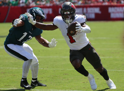 Sep 29, 2024; Tampa, Florida, USA; Tampa Bay Buccaneers running back Rachaad White (1) runs  past Philadelphia Eagles linebacker Nakobe Dean (17) during the first quarter at Raymond James Stadium. Mandatory Credit: Kim Klement Neitzel-Imagn Images