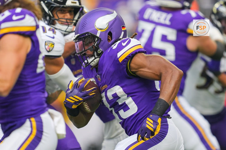 Nov 9, 2025; Minneapolis, Minnesota, USA; Minnesota Vikings running back Aaron Jones Sr. (33) runs with the ball against Baltimore Ravens in the first quarter at U.S. Bank Stadium. Credit: Brad Rempel-Imagn Images