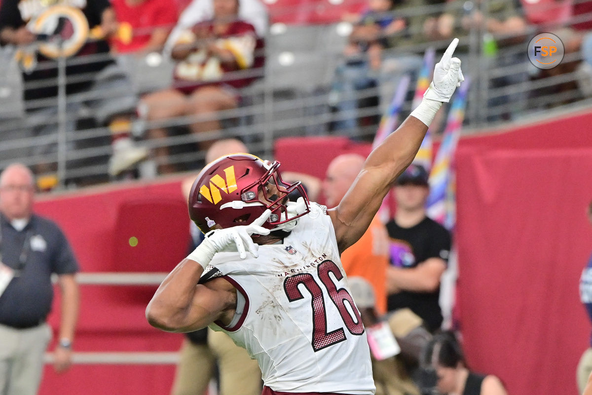 Sep 29, 2024; Glendale, Arizona, USA;  Washington Commanders running back Jeremy McNichols (26) scores a touchdown in the second half against the Arizona Cardinals at State Farm Stadium. Credit: Matt Kartozian-Imagn Images