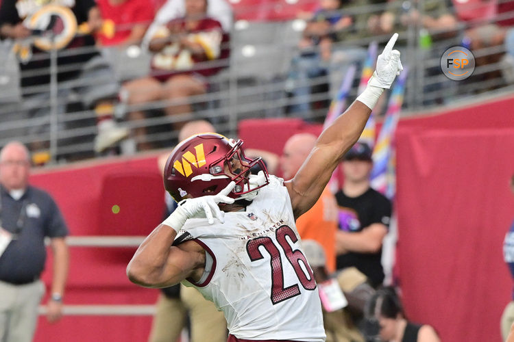 Sep 29, 2024; Glendale, Arizona, USA;  Washington Commanders running back Jeremy McNichols (26) scores a touchdown in the second half against the Arizona Cardinals at State Farm Stadium. Credit: Matt Kartozian-Imagn Images