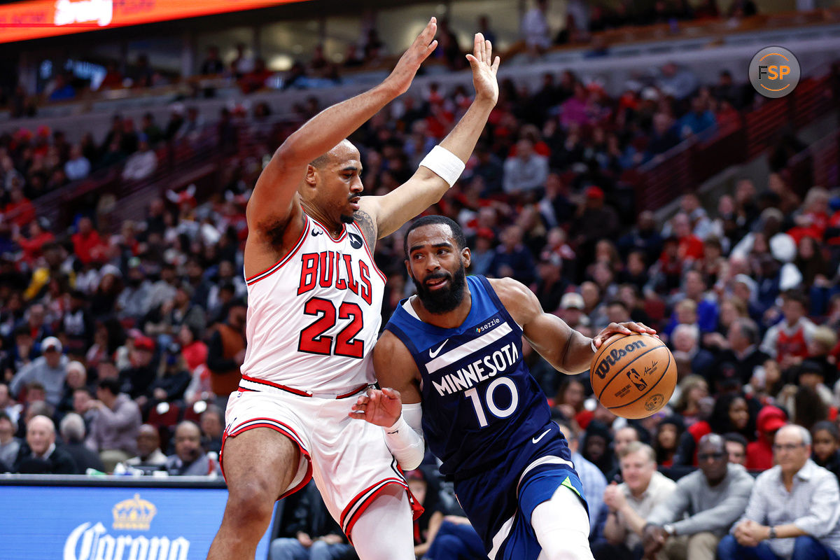 Oct 16, 2024; Chicago, Illinois, USA; Minnesota Timberwolves guard Mike Conley (10) drives to the basket against Chicago Bulls forward Talen Horton-Tucker (22) during the first half at United Center. Credit: Kamil Krzaczynski-Imagn Images